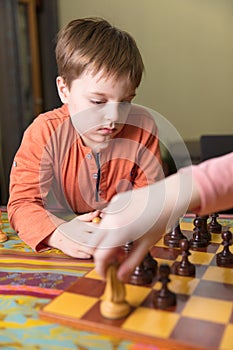 Brother and sister playing chess