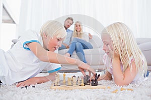 Brother and sister playing chess