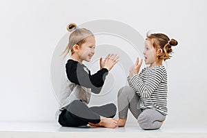 Brother and sister playing a clap game, having fun competing