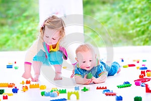 Brother and sister playing with colorful blocks