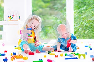 Brother and sister playing with colorful blocks