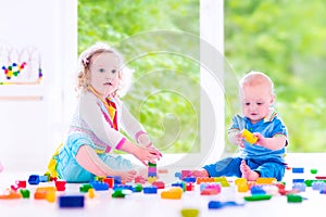 Brother and sister playing with colorful blocks