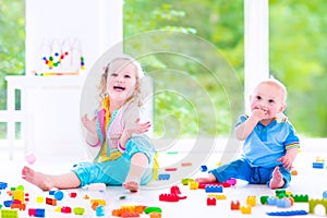 Brother and sister playing with colorful blocks