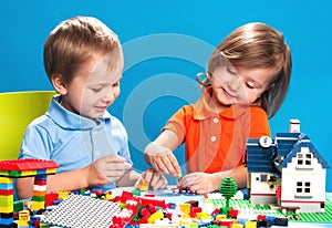 Brother and sister playing with construction blocks