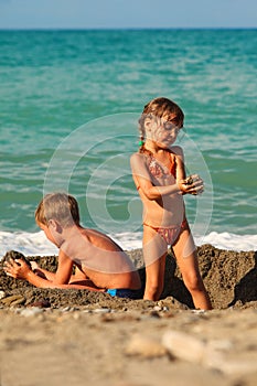 Brother and sister playing after swim at beach