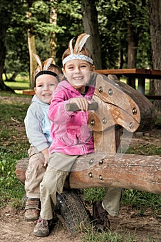 Brother and sister playing on the swing