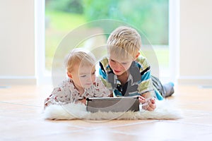 Brother and sister playing with tablet pc