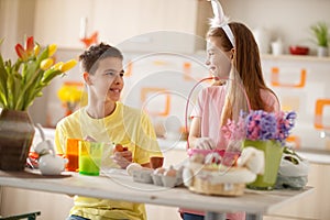 Brother and sister preparing Easter colorful eggs
