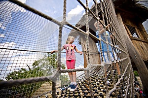 Brother and sister on rope ladder