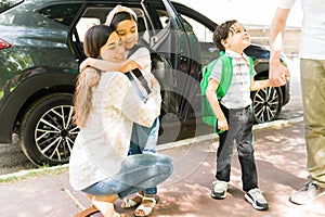 Brother and sister saying goodbye to mom and dad