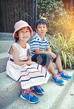 Brother and sister smiling happily. Vintage tone.