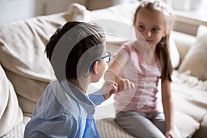 Brother and sister squeeze little fingers as sign of reconciliation