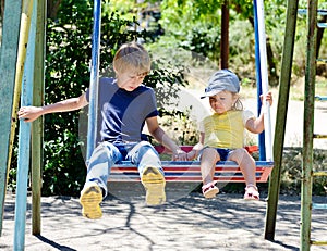 Brother and sister on the swing