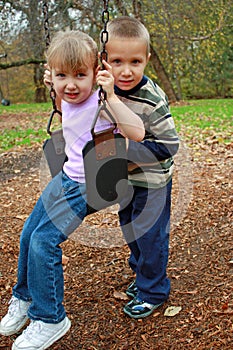 Brother and sister swinging