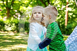 Brother and sister walk in the park. Preschool children. 2-3 yea