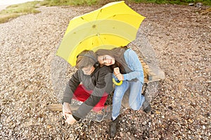 Brother and sister with yellow umbrella