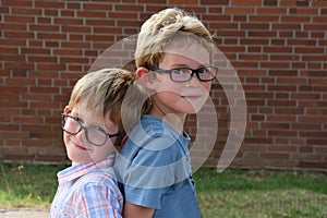 Brothers, both with glasses playing together