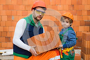 Brothers bricklayers make masonry, builders work with brick layer.