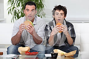 Brothers eating hamburgers