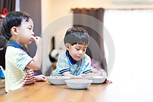 The brothers are enjoying their favorite omelet before going to school