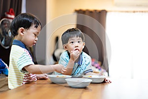 The brothers are enjoying their favorite omelet before going to school