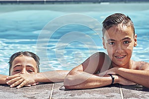 Brothers with green eyes in the swimming pool