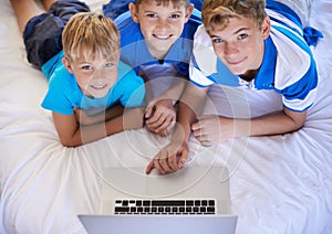 Brothers, home and playing on laptop in bedroom, above and excited for online games in house. Young children, mousepad