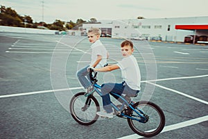 Brothers making tricks riding on one bike together