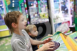 Brothers playing arcade game