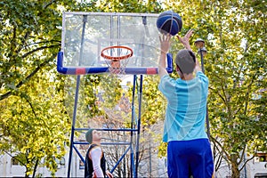 Brothers playing basketball One On One.