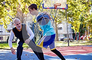 Brothers playing basketball One On One.