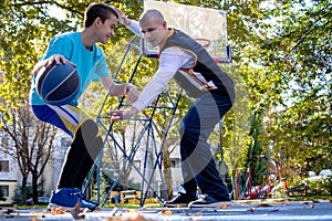 Brothers playing basketball One On One.