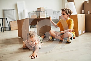 Brothers Playing with Boxes in New Home