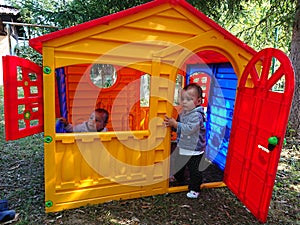 Brothers playing in a play house