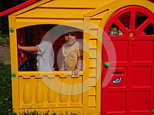 Brothers playing in a play house