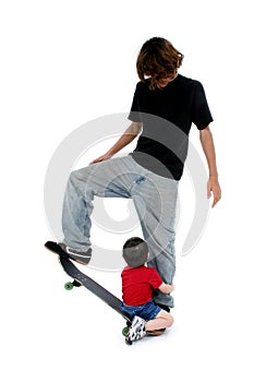 Brothers Playing On Skateboard
