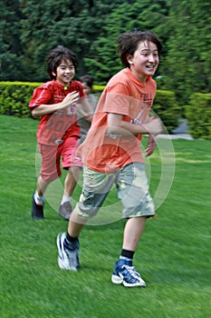 Brothers playing tag at the park