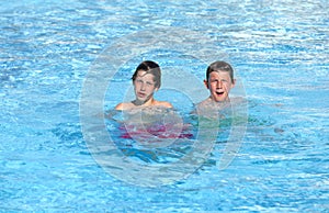 Brothers playing together in the pool