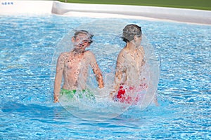 Brothers playing together in the pool