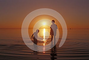 Brothers playing in the water at the Great Salt Lake beach