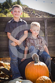 Brothers at the Pumpkin Patch Against Antique Wood Wagon