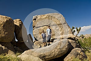 Brothers on a rock at yoshua tree