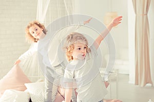 Brothers standing on the bed