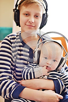 Brothers  wearing headphones