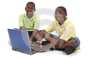 Brothers Working On Laptop Computer Sitting On Floor