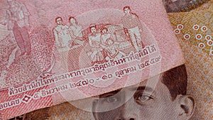 Brown 1000 baht and red 100 baht banknote THB