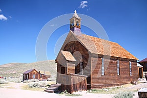 The brown abandoned ghost church of Bodie with the blue sky on the background