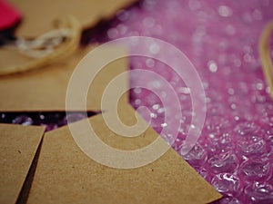 Brown address label gift tag and bubble wrap background close up shot