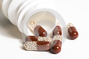 Brown antibiotic capsules with bottle