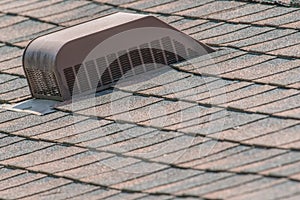 Brown asphalt shingled roof and roff vent